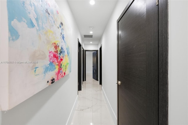 hall with recessed lighting, marble finish floor, visible vents, and baseboards