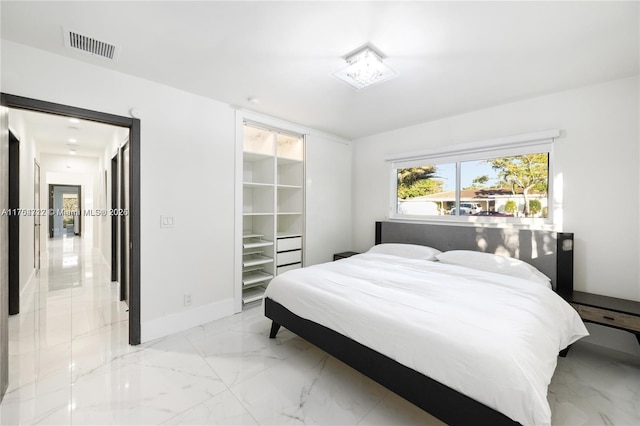 bedroom with marble finish floor, baseboards, and visible vents