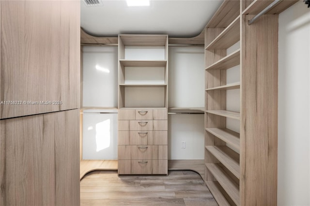 walk in closet featuring wood finished floors and visible vents