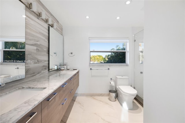 bathroom featuring double vanity, baseboards, toilet, marble finish floor, and recessed lighting