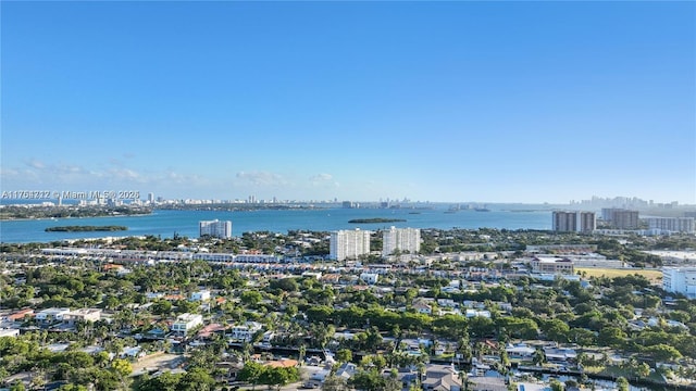 drone / aerial view featuring a city view and a water view