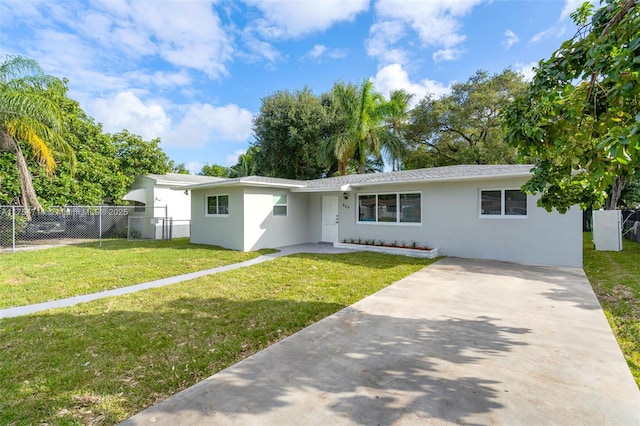 single story home with a front yard, fence, driveway, and stucco siding