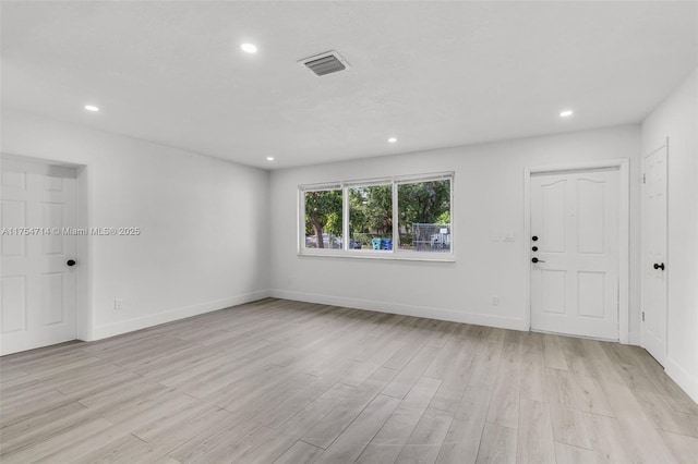 empty room with recessed lighting, visible vents, and light wood-style floors