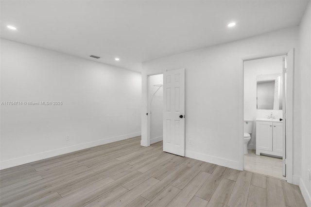 unfurnished bedroom with light wood-type flooring, visible vents, baseboards, and recessed lighting