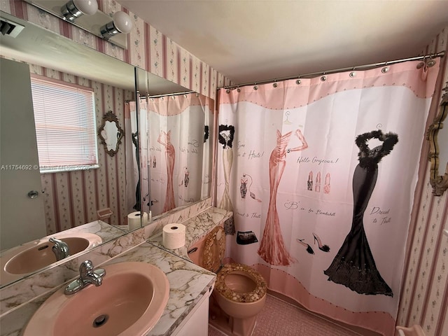 bathroom with a shower with shower curtain, vanity, toilet, and wallpapered walls