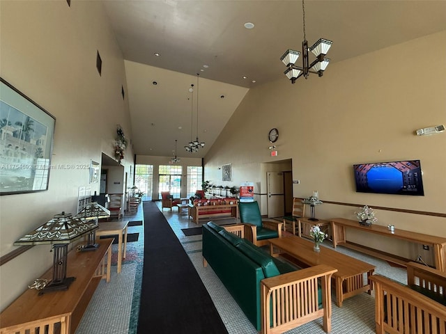 carpeted living area with high vaulted ceiling and a notable chandelier