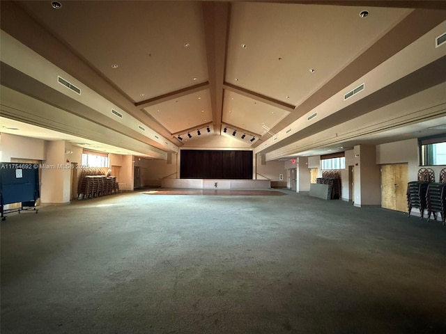 interior space with lofted ceiling with beams, carpet, and visible vents