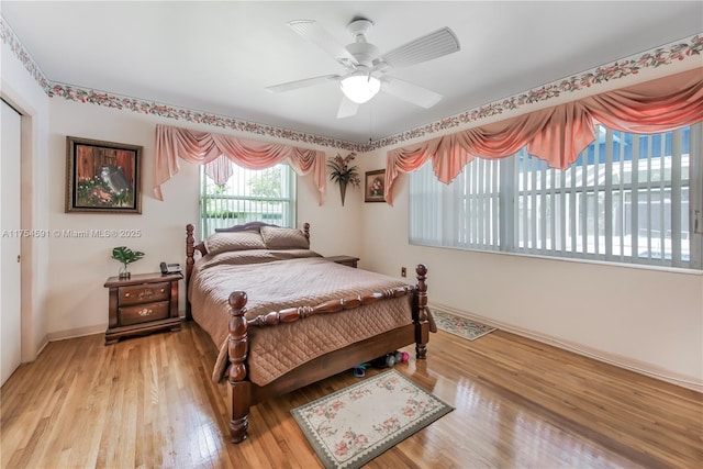 bedroom featuring light wood-style floors, ceiling fan, and baseboards