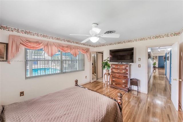 bedroom with ceiling fan, light wood finished floors, and visible vents