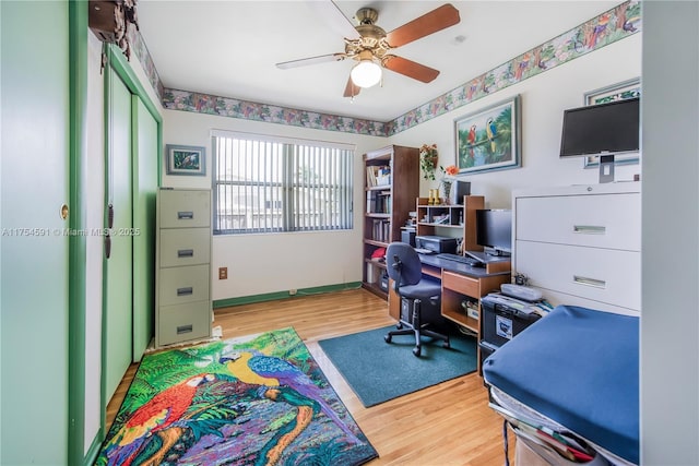 office with wood finished floors, a ceiling fan, and baseboards