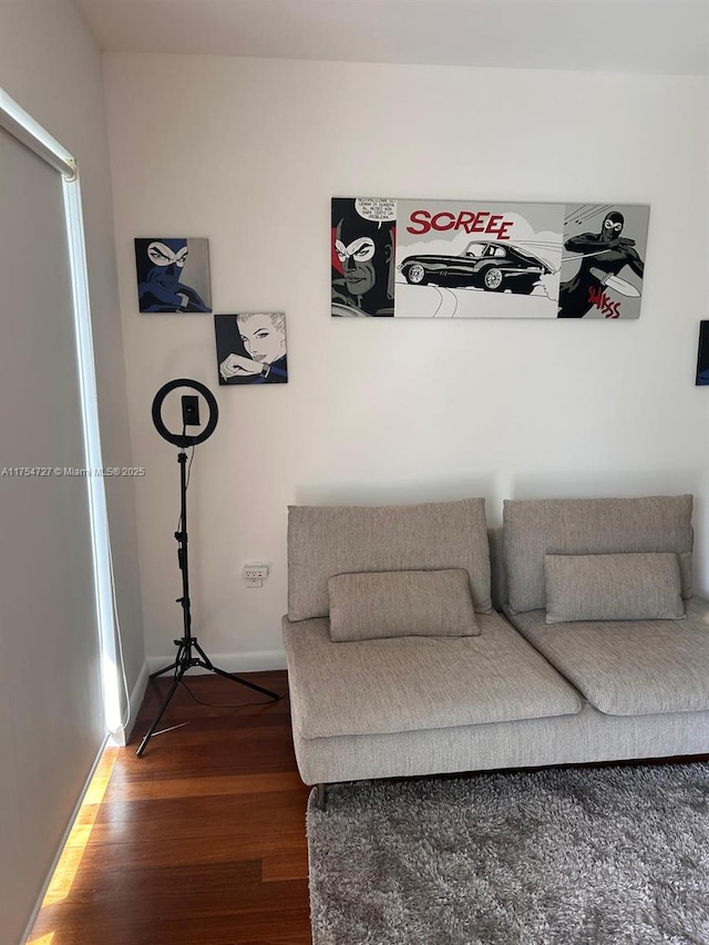 living area featuring baseboards and wood finished floors