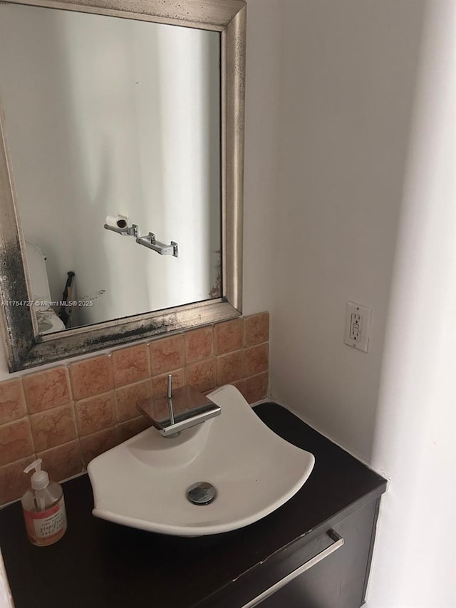 bathroom featuring backsplash and a sink