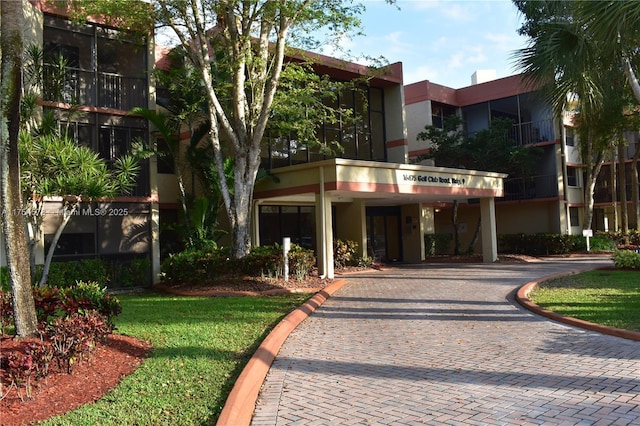 view of building exterior featuring decorative driveway