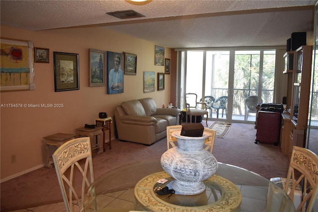 dining space with visible vents, light carpet, a textured ceiling, and floor to ceiling windows