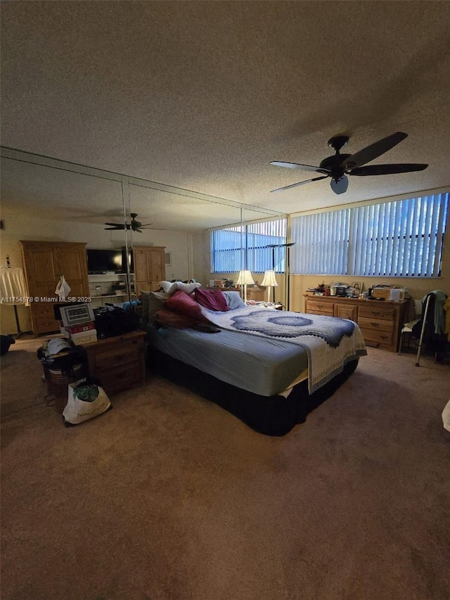 bedroom with a textured ceiling, a ceiling fan, and carpet floors