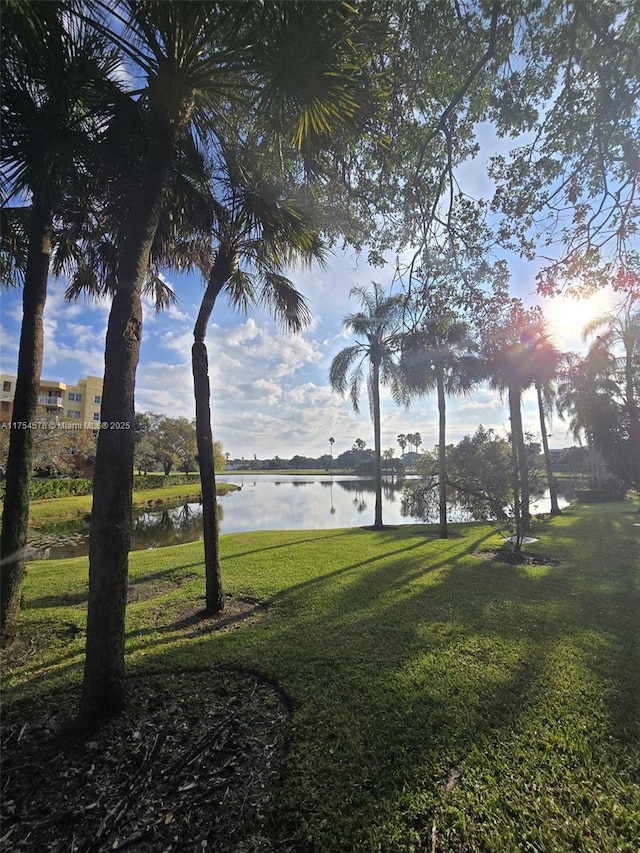 view of home's community featuring a lawn and a water view