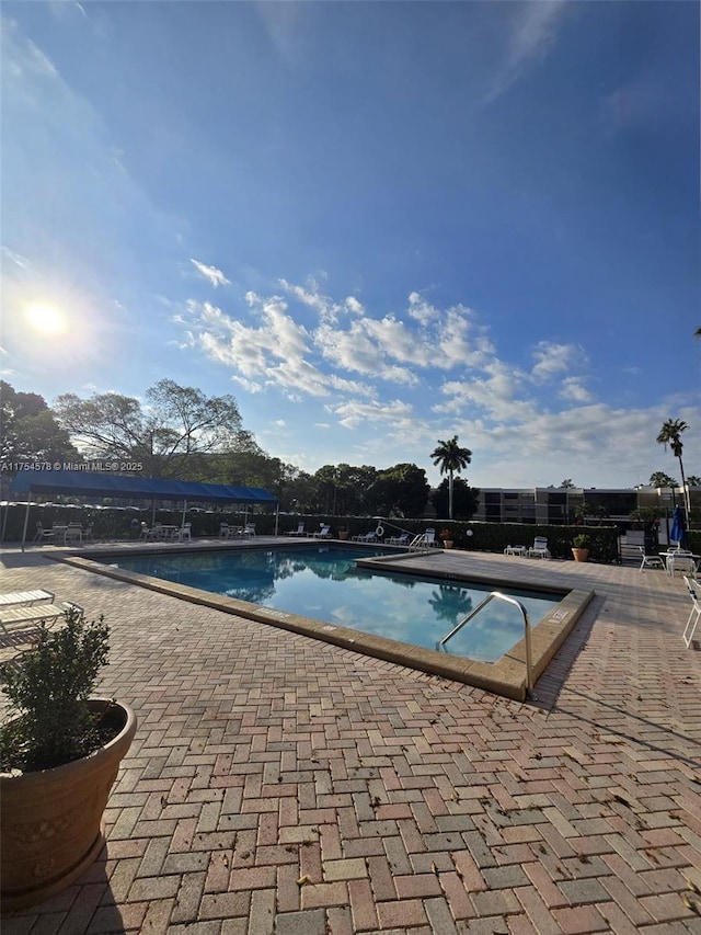 community pool with a patio area