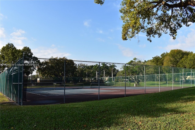 view of sport court featuring a yard and fence