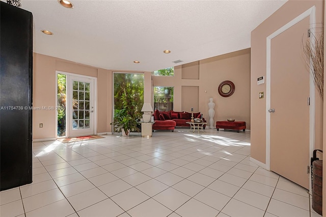 interior space with baseboards, recessed lighting, light tile patterned flooring, and visible vents