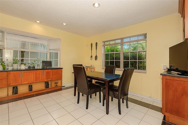 dining area featuring light tile patterned floors, recessed lighting, and a textured ceiling
