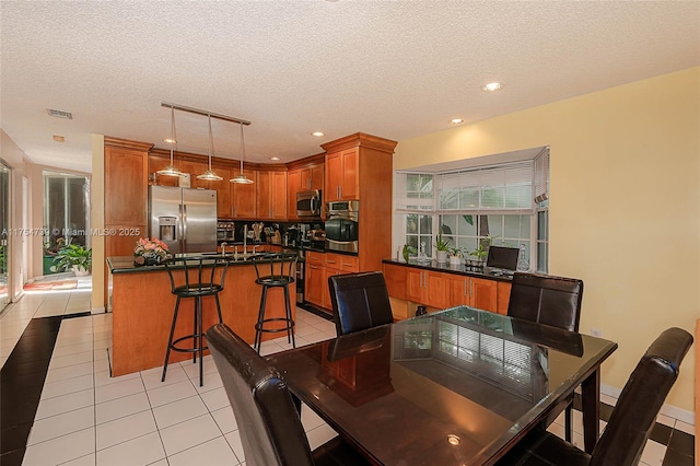 dining area with recessed lighting, a textured ceiling, visible vents, and light tile patterned floors
