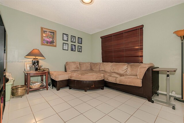 living room featuring a textured ceiling and light tile patterned floors