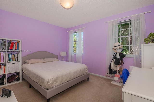 bedroom featuring carpet flooring and a textured ceiling