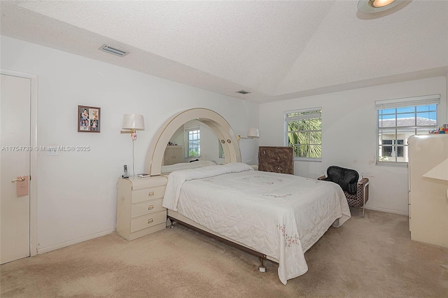 carpeted bedroom featuring baseboards, a textured ceiling, and visible vents