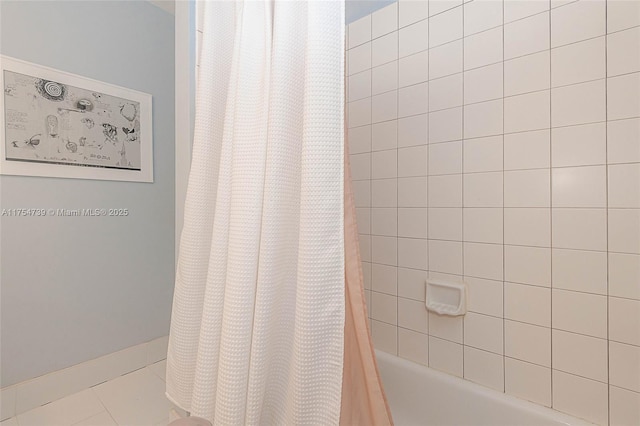 bathroom with shower / tub combo with curtain and tile patterned floors