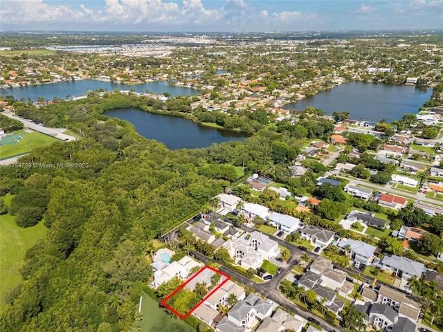 drone / aerial view with a water view and a residential view