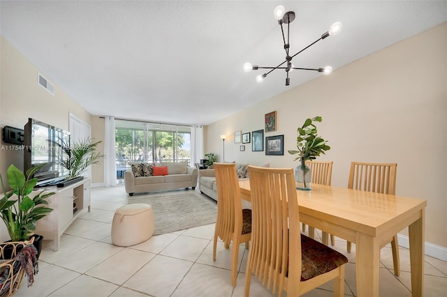 dining room featuring light tile patterned floors, a chandelier, and visible vents