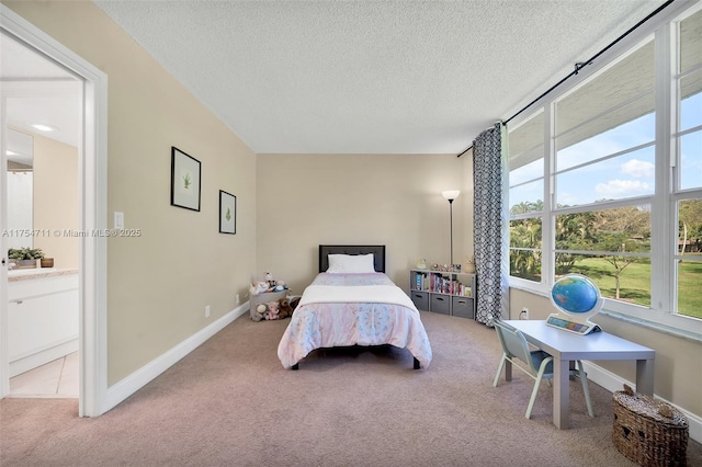 bedroom with a textured ceiling, carpet, and baseboards