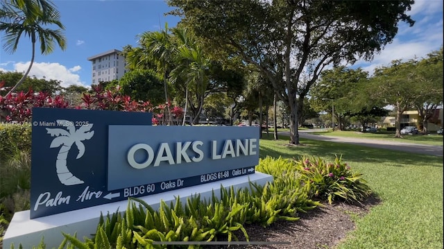 community sign featuring a lawn