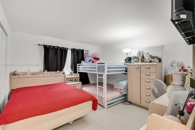 bedroom featuring light tile patterned floors and a closet