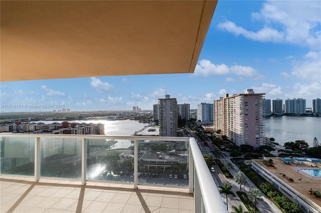 balcony with a water view and a city view