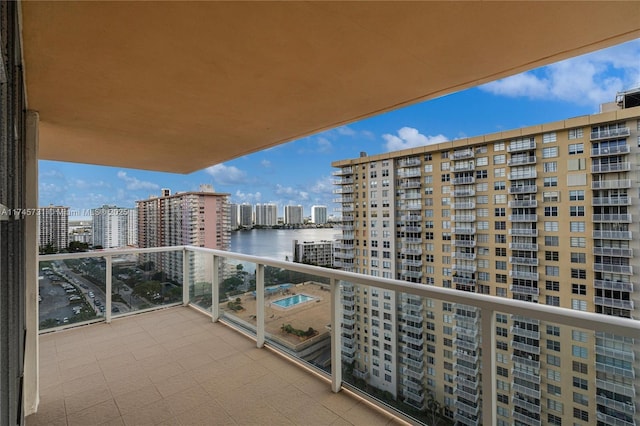 balcony featuring a view of city and a water view