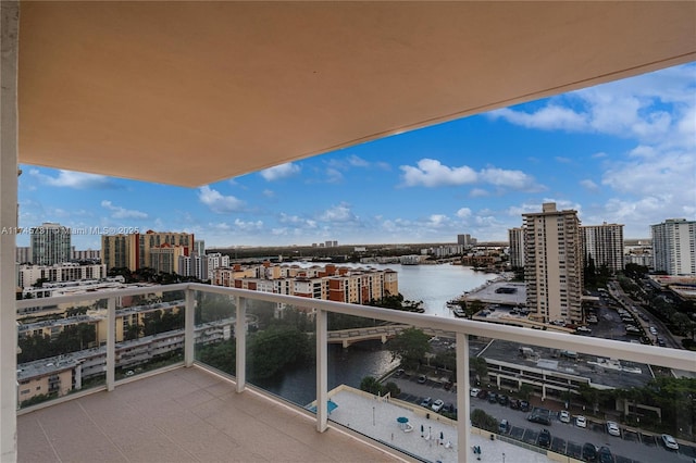 balcony featuring a water view and a view of city