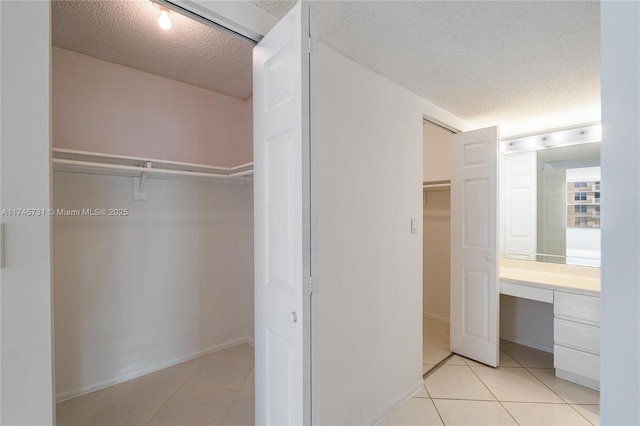 interior space featuring built in study area and light tile patterned floors