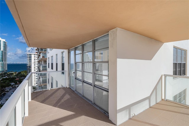 balcony featuring a view of city and a water view