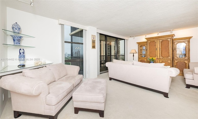 living area with light carpet, floor to ceiling windows, and a textured ceiling