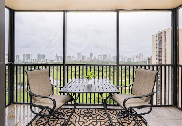 sunroom featuring a city view