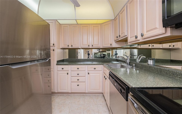 kitchen featuring black microwave, light tile patterned floors, a sink, stainless steel dishwasher, and dark countertops