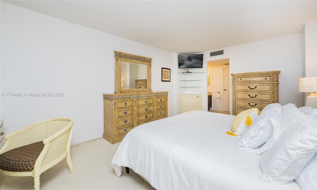 bedroom featuring light carpet and visible vents