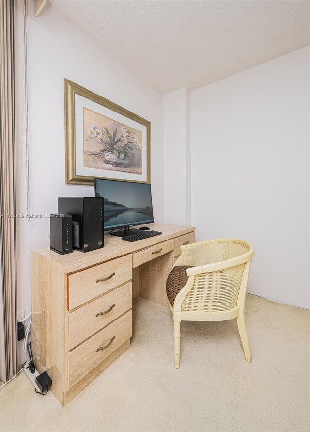 carpeted home office with built in desk