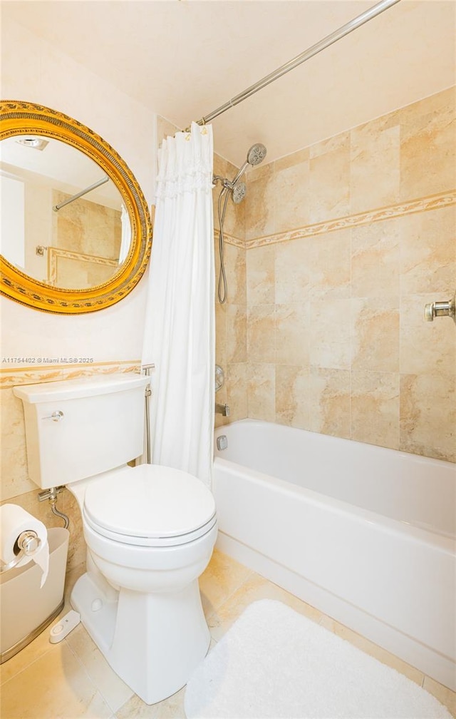 bathroom featuring shower / bath combo, tile patterned flooring, and toilet