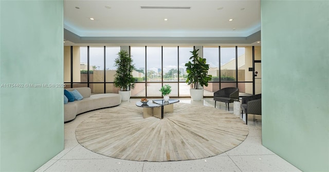 living room with recessed lighting, a wealth of natural light, and floor to ceiling windows