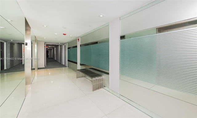 hall featuring light tile patterned floors