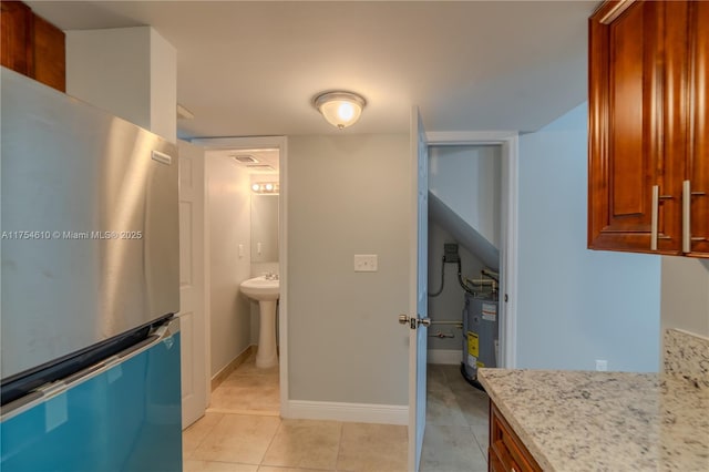 1955 NW 5th Pl Unit 13, Miami, FL 33136 - bathroom with water heater, baseboards, and tile patterned floors
