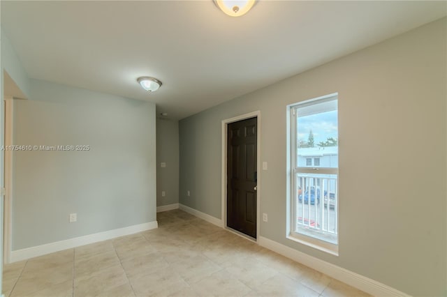 1955 NW 5th Pl Unit 13, Miami, FL 33136 - spare room featuring a healthy amount of sunlight, baseboards, and light tile patterned flooring
