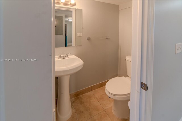 1955 NW 5th Pl Unit 13, Miami, FL 33136 - half bathroom with baseboards, toilet, and tile patterned floors